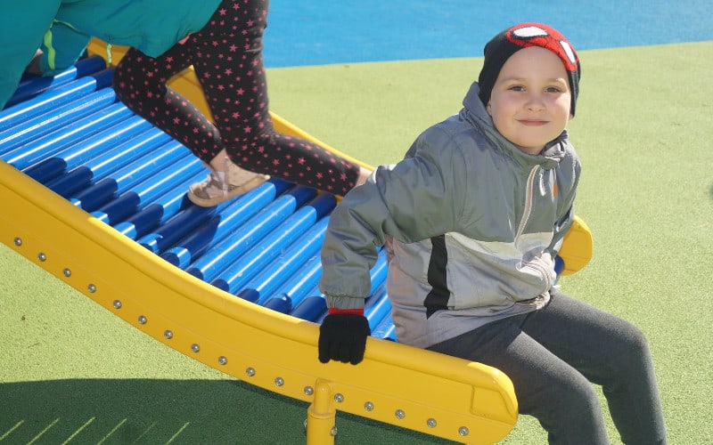 Child sliding at Milestone playground
